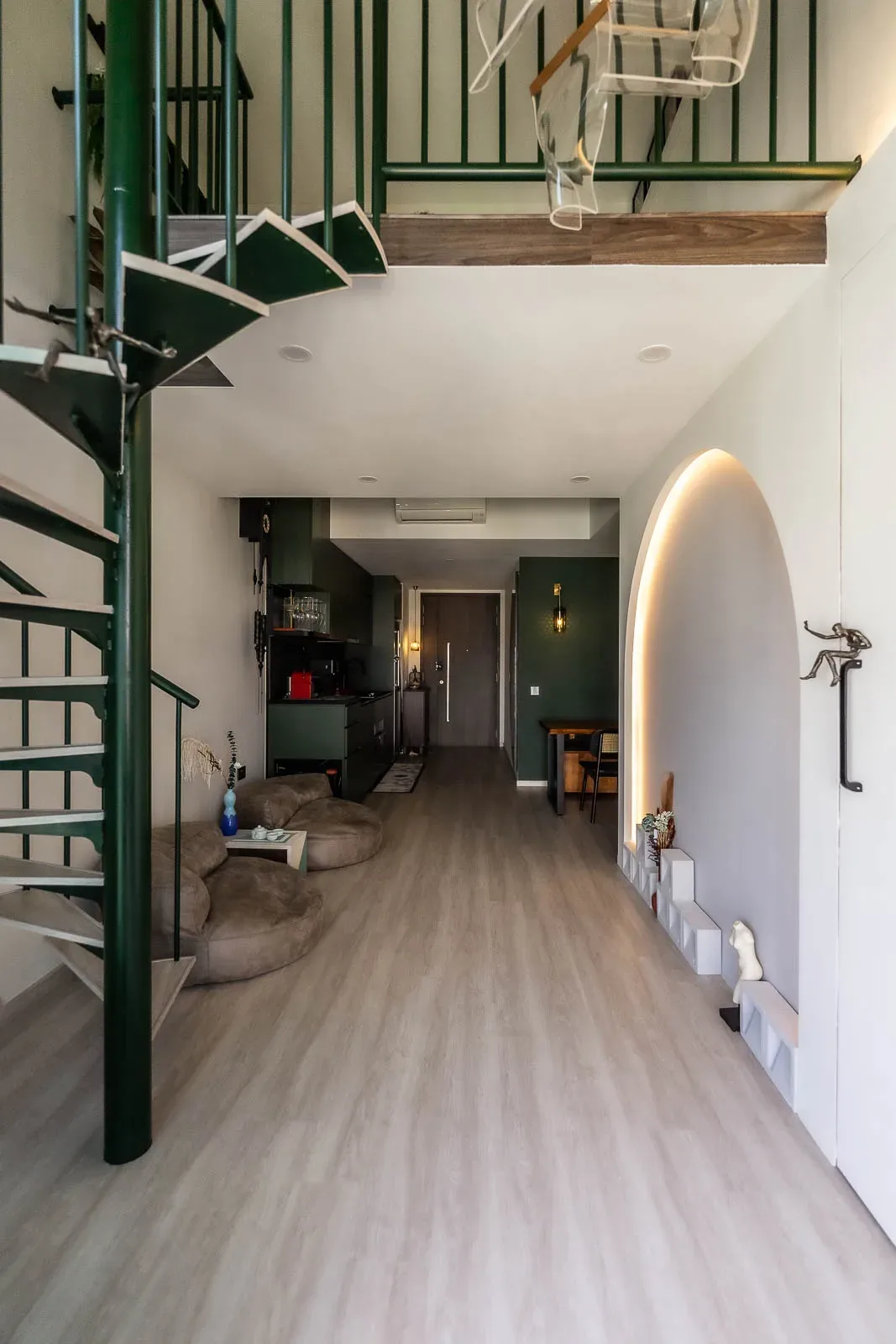 Modern loft interior with spiral staircase and unique lighting.