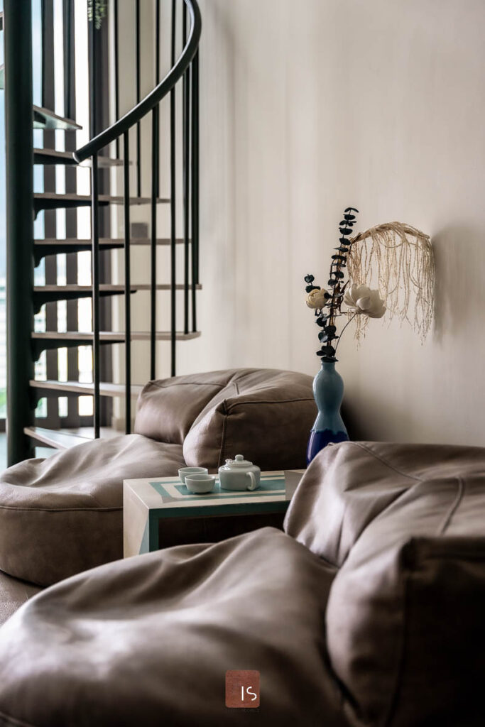 Elegant interior design of a Singapore living room by IS Design Studio, featuring luxurious furnishings and tasteful decor, emphasizing the studio's commitment to quality and style.