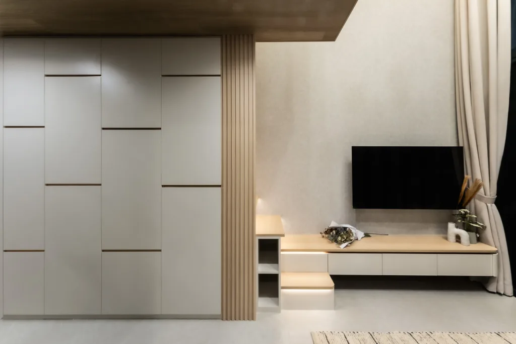 Modern minimalist interior with built-in furniture and TV.
