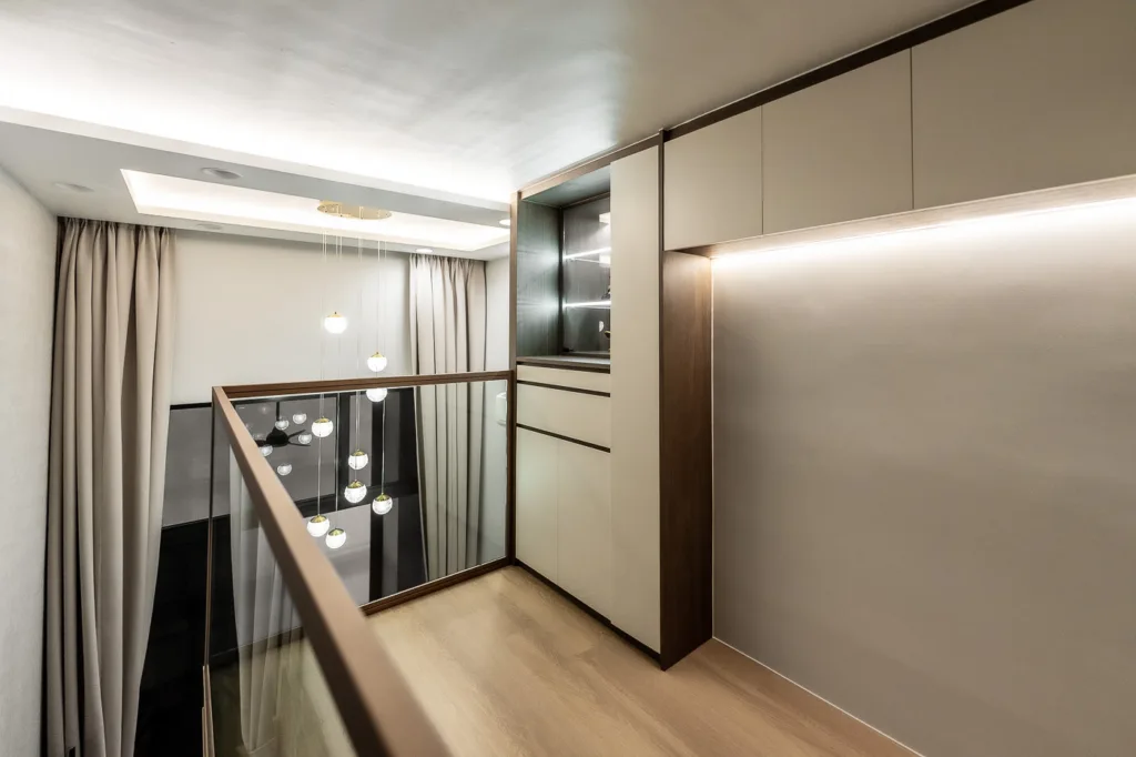 Modern hallway interior with pendant lights and wood accents.