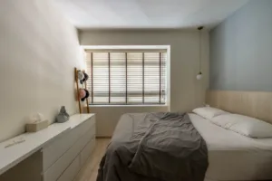Modern minimalist bedroom interior with natural light.