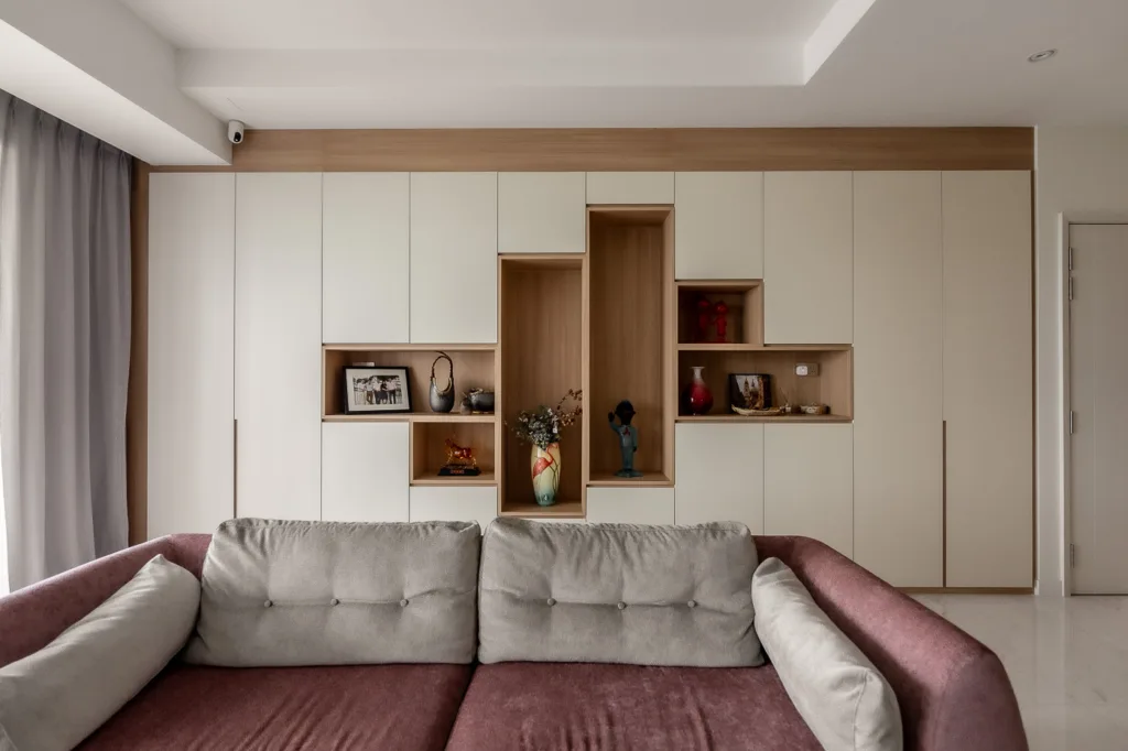 Modern living room with elegant decor and built-in shelves.