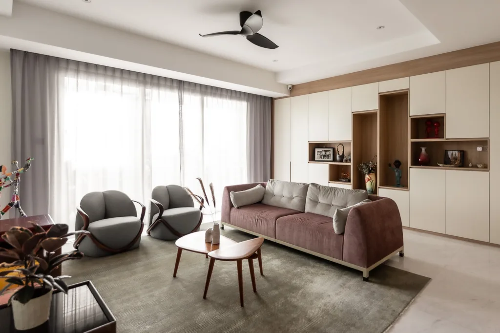 Modern living room with furniture and natural light.
