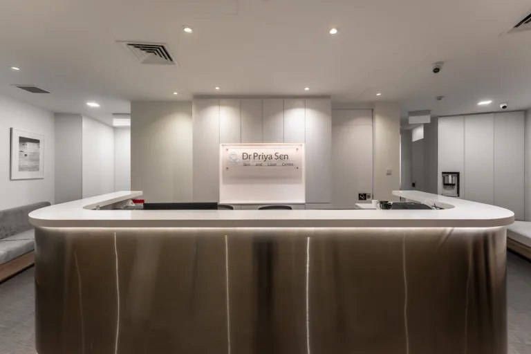 Modern clinic reception desk and waiting area.