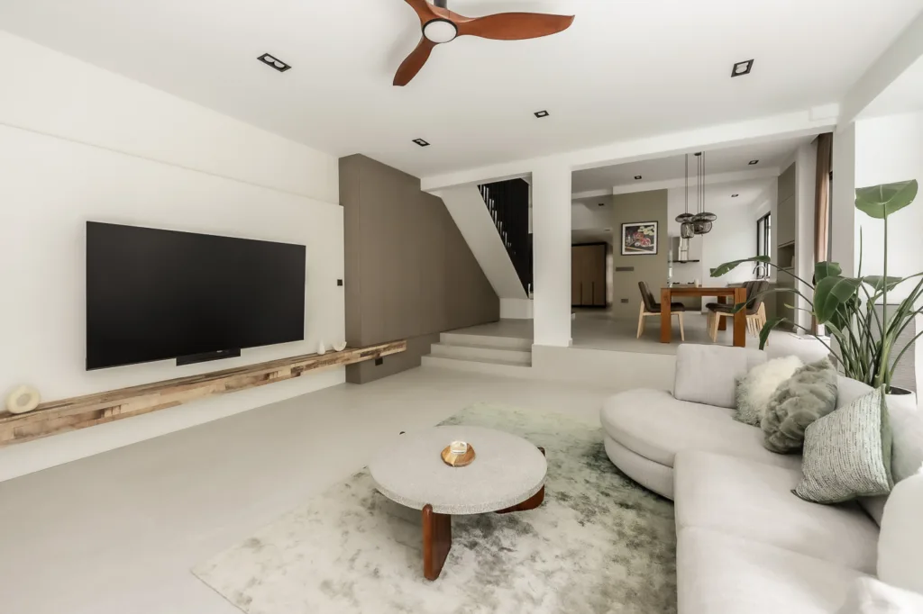 Modern living room interior with sectional sofa and TV.