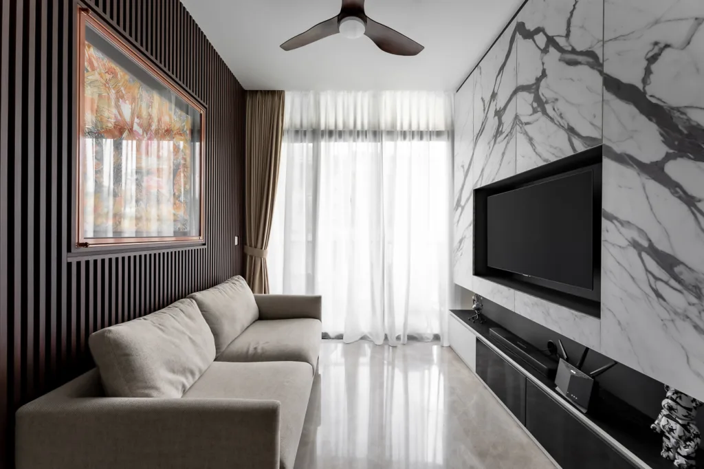 Modern living room with marble wall and striped decor.