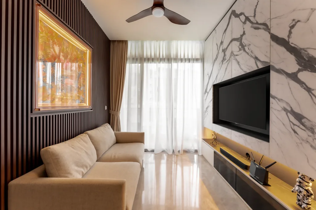 Modern living room with marble wall and mounted TV.