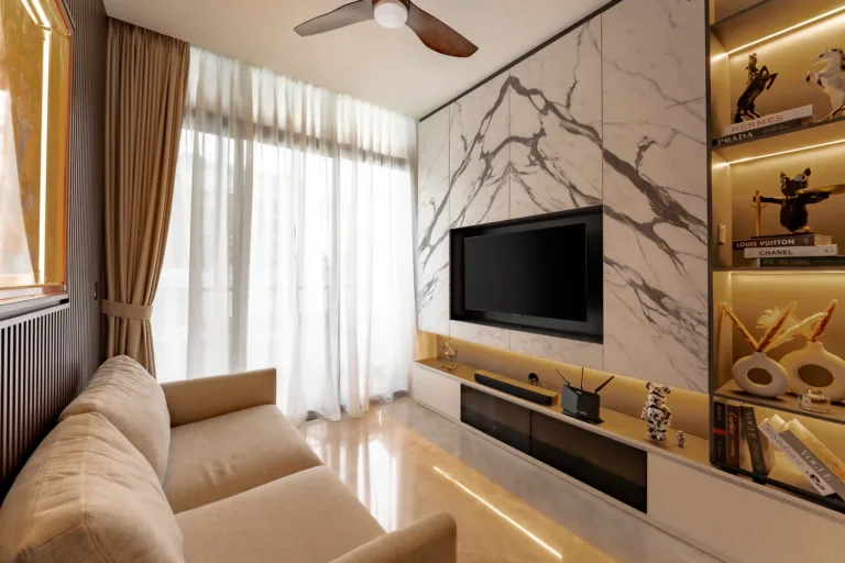 Modern living room with marble wall and mounted TV.