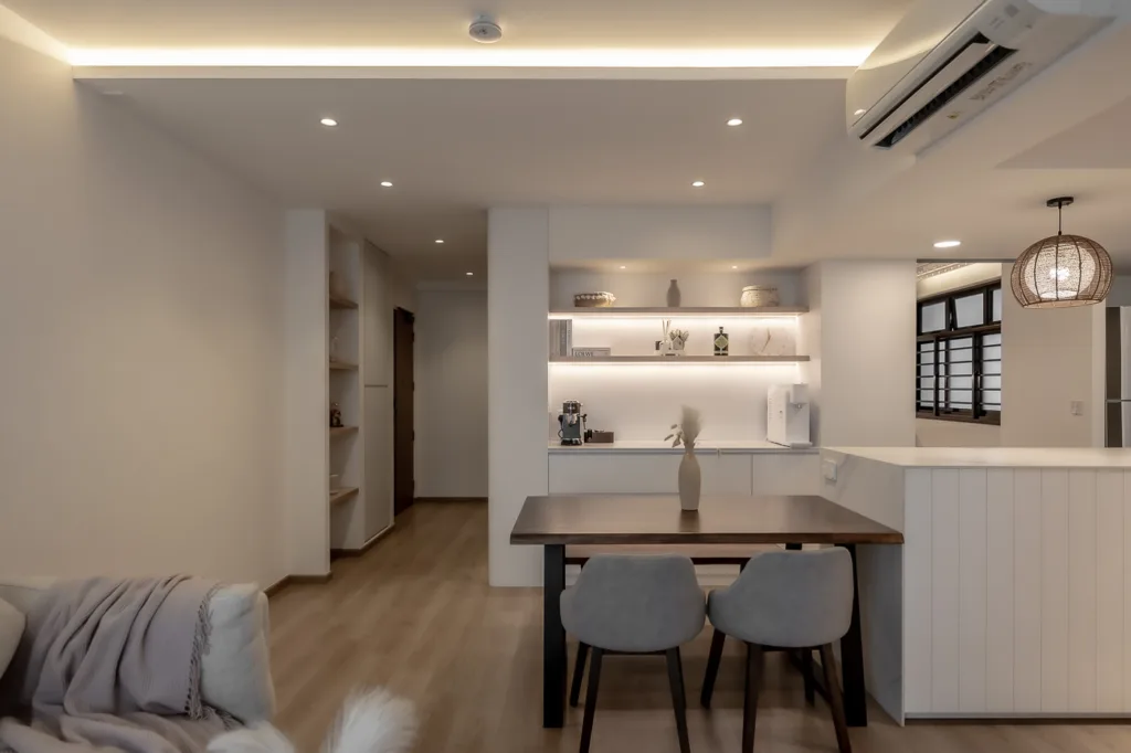 Modern kitchen interior with dining area and cozy lighting.