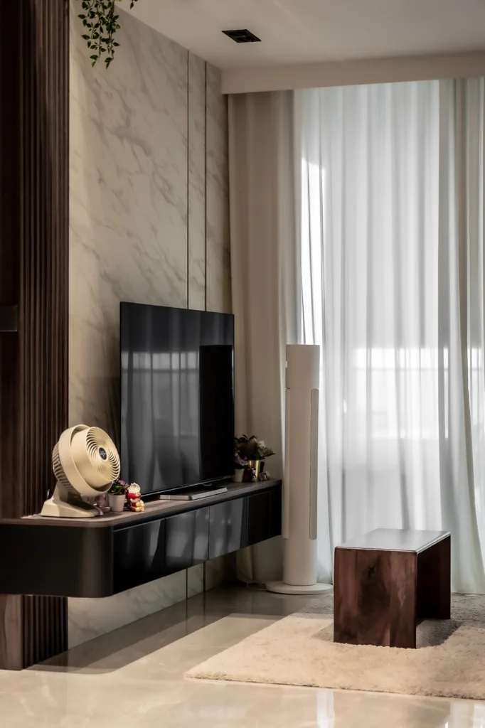 Modern living room with TV and elegant decor.