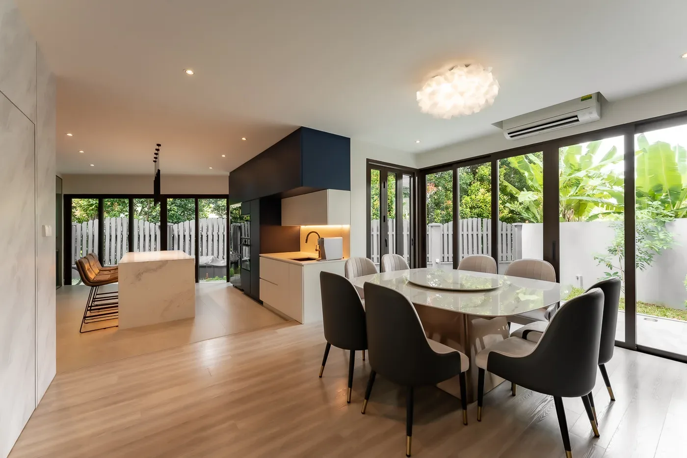 Modern kitchen and dining interior with garden view.