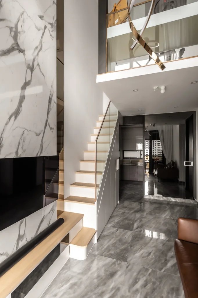 Modern marble interior with staircase and luxury lighting.