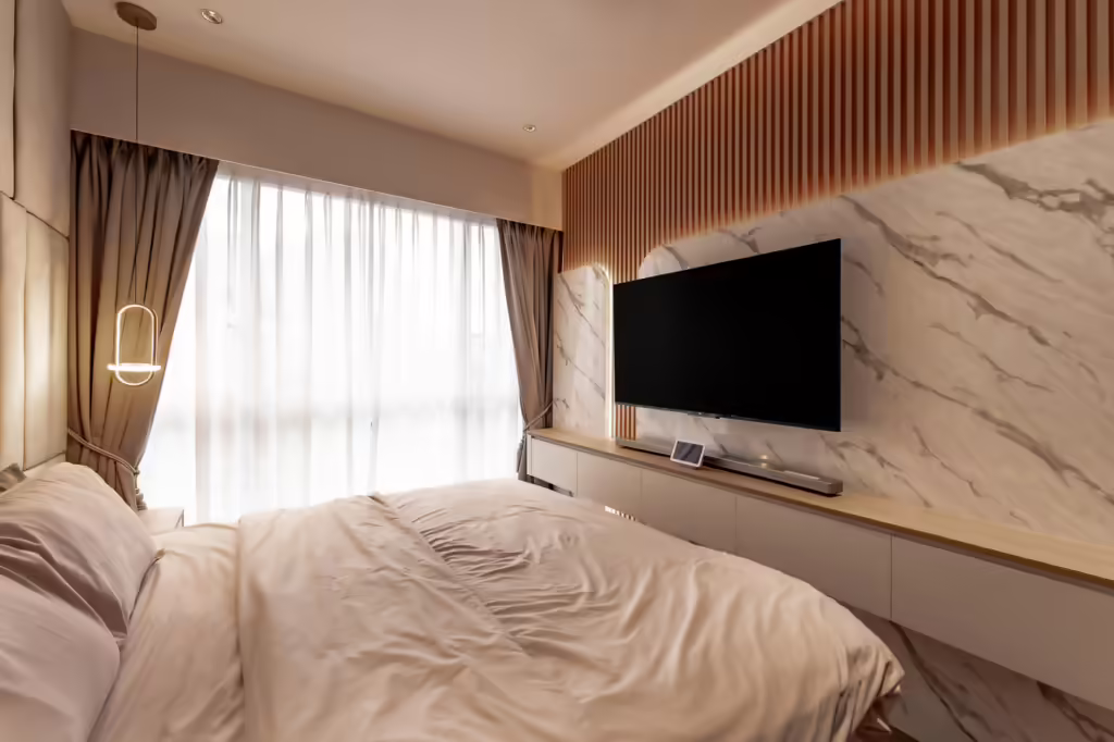 Modern bedroom at 24 Sumang Walk with large bed, TV, and marble wall.