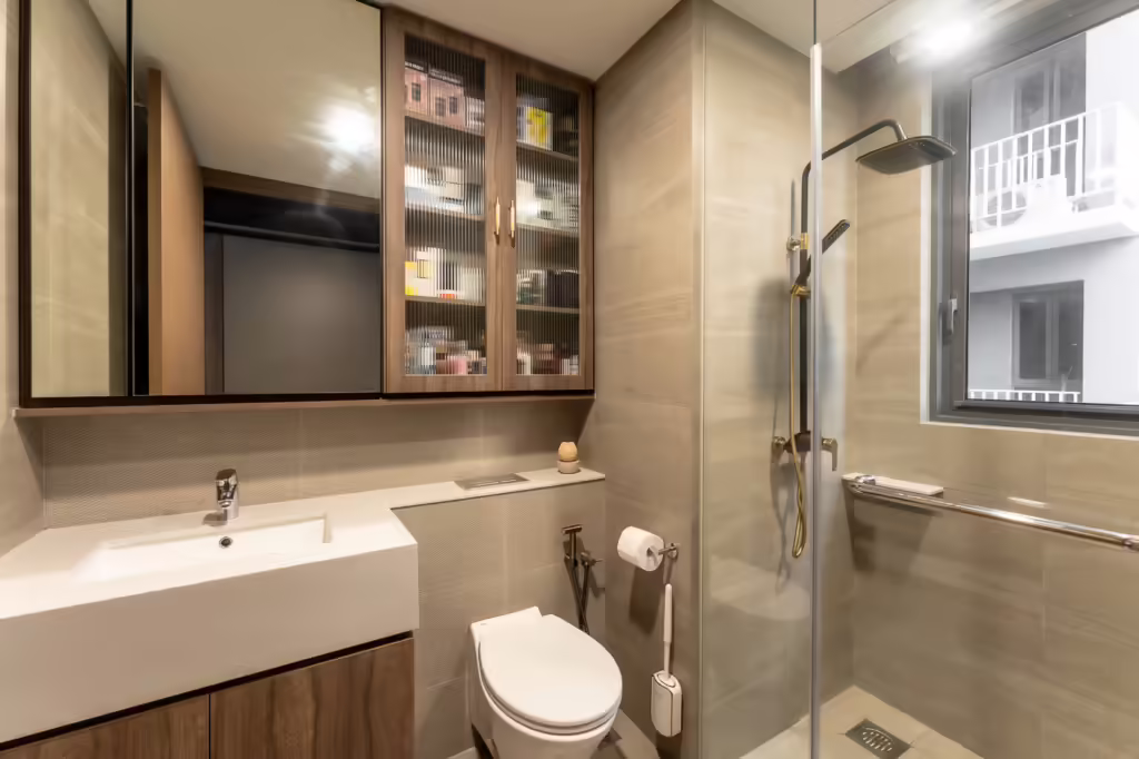 Modern bathroom at 24 Sumang Walk with glass shower, vanity, and toilet.