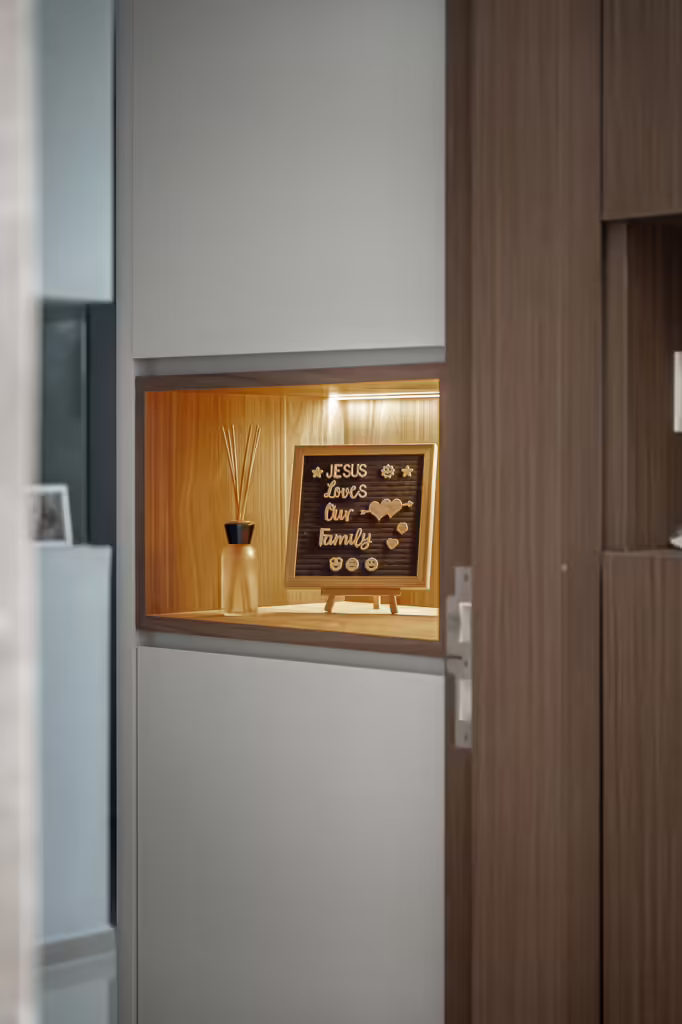 Illuminated niche with "Jesus Loves Our Family" letterboard and diffuser in a 32 Sumang Walk loft.