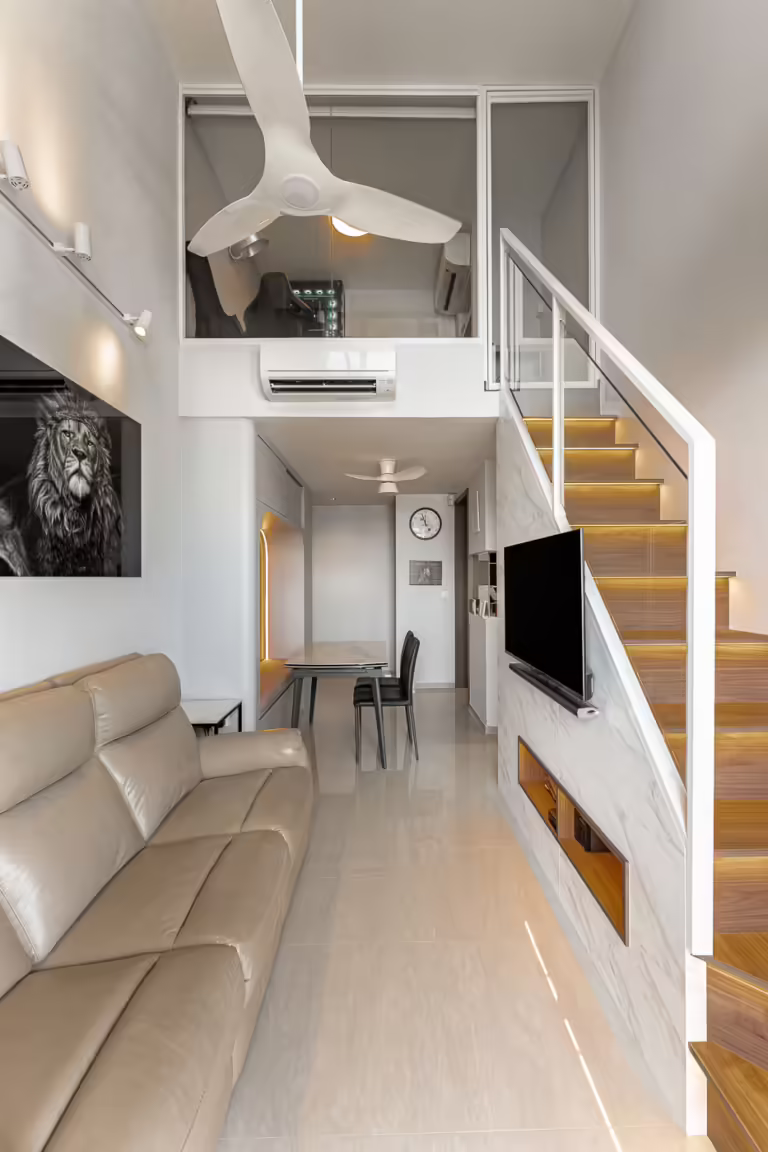 Modern open-plan apartment with loft, stairs, and beige leather sofa.