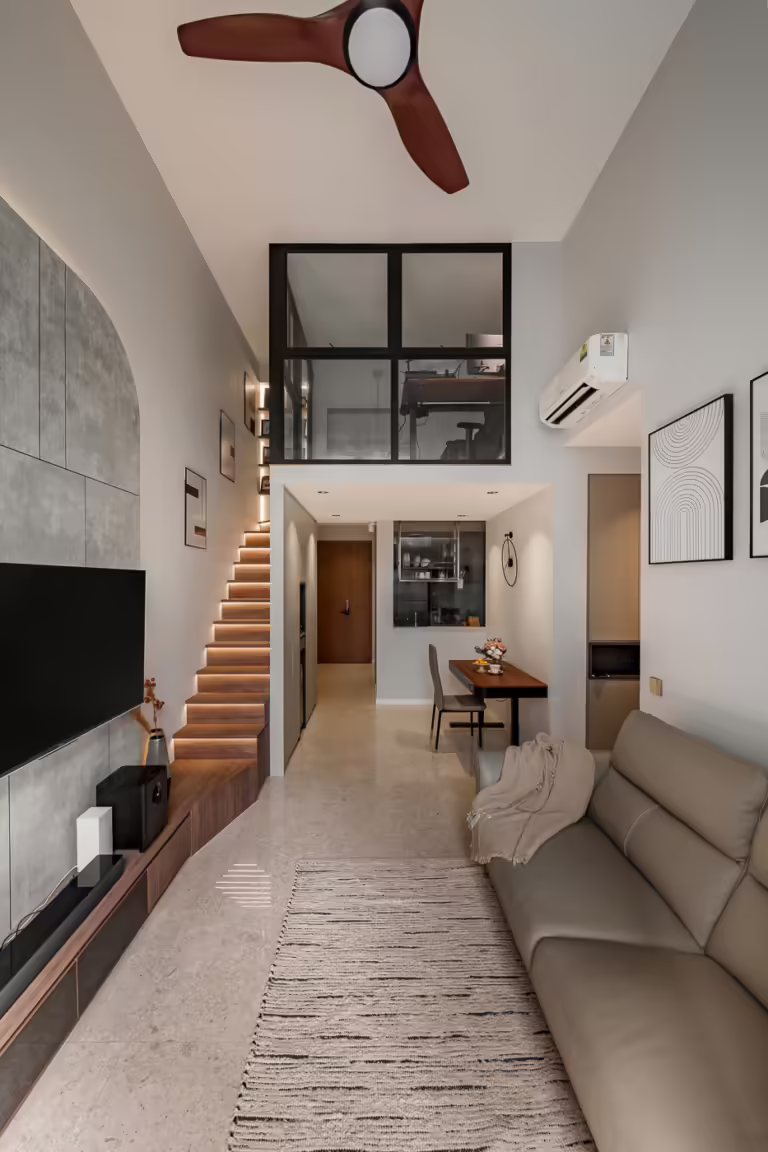 Modern loft apartment interior with open staircase and mezzanine level.