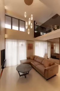 Modern living room in Serangoon North with leather sectional sofa and chandelier.