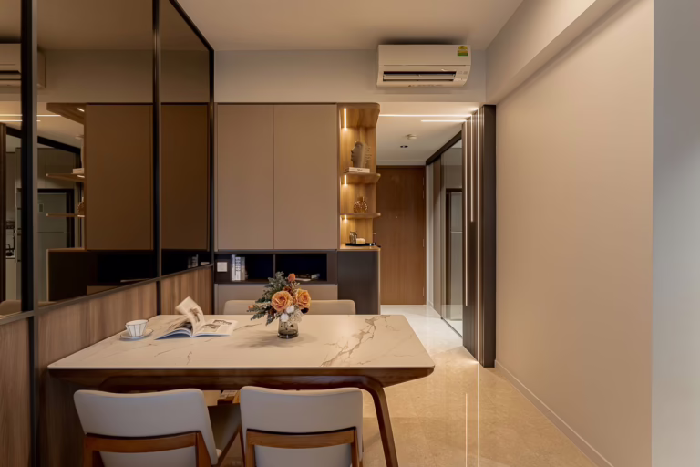 Modern dining room with marble table, wooden chairs, and built-in cabinetry.