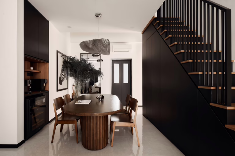 Modern dining room with dark wood table and chairs, located in the 2 Indus Road home.