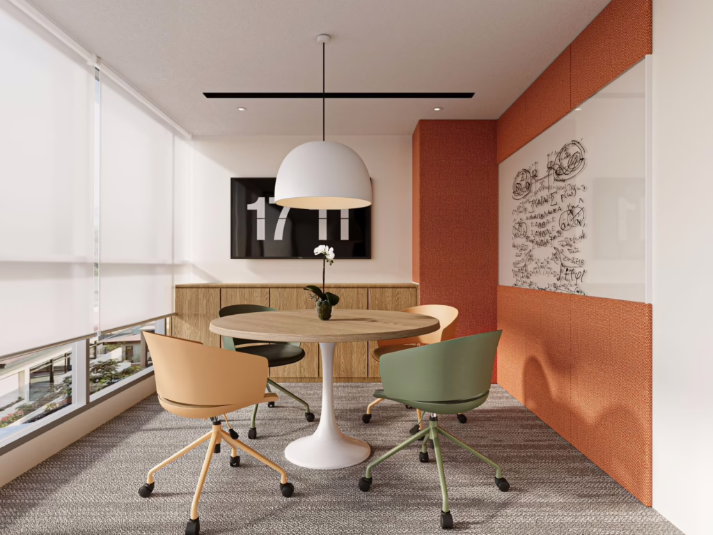 Modern office meeting room with round table, chairs, and whiteboard.