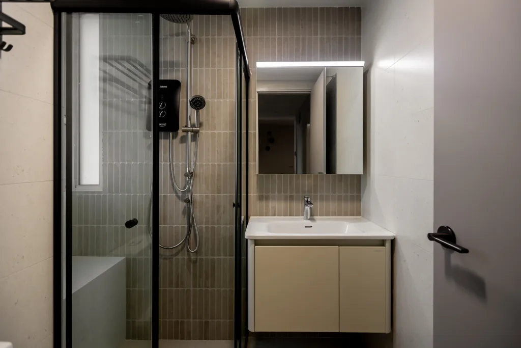 Modern small bathroom with beige subway tile, walk-in shower, and floating vanity.