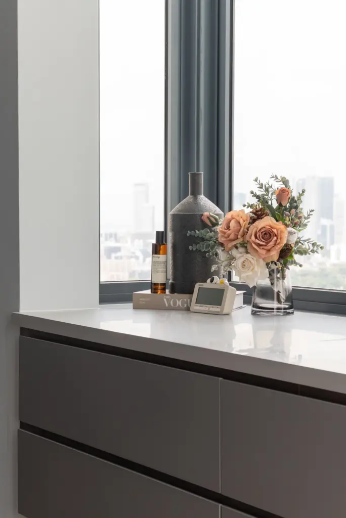 Modern decor with vase, flowers, and books on table.