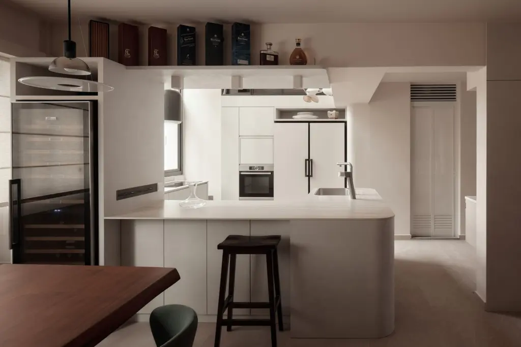 Modern kitchen with sleek countertops and appliances. — at Kim Keat Avenue, an HDB executive maisonette by IS Design Studio