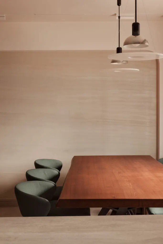 Modern dining table with pendant lights and chairs.