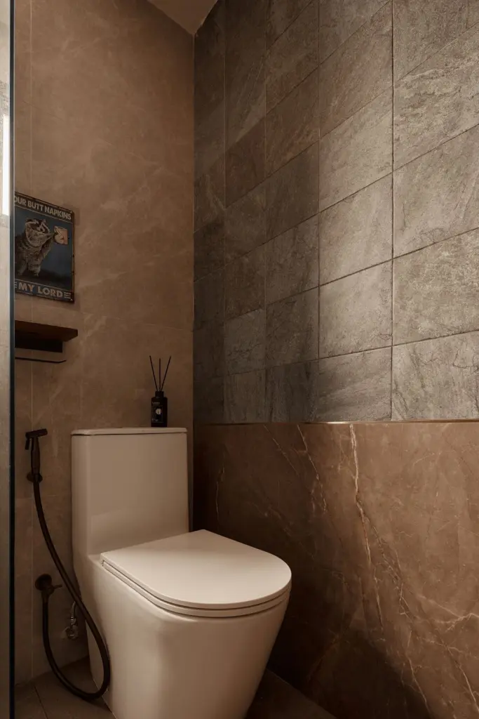 Modern bathroom with marble walls and toilet.