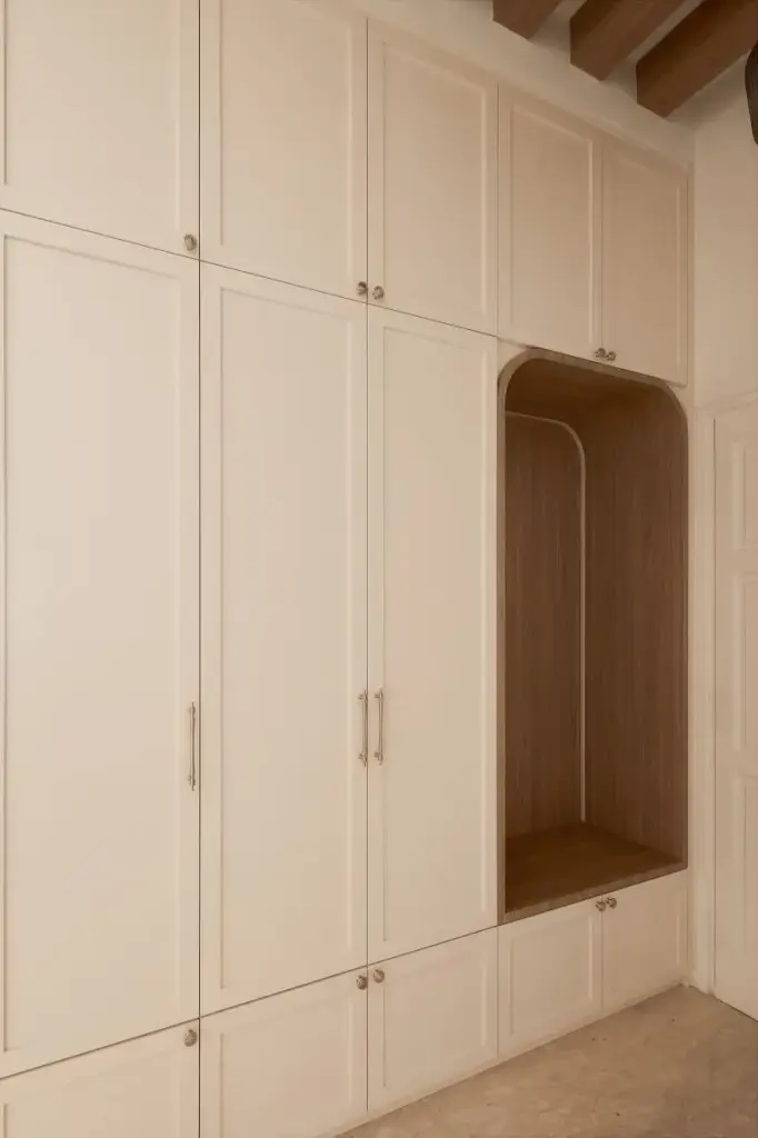 Built-in beige cabinets with seating area — at Eastwood, a modern luxury condo by IS Design Studio