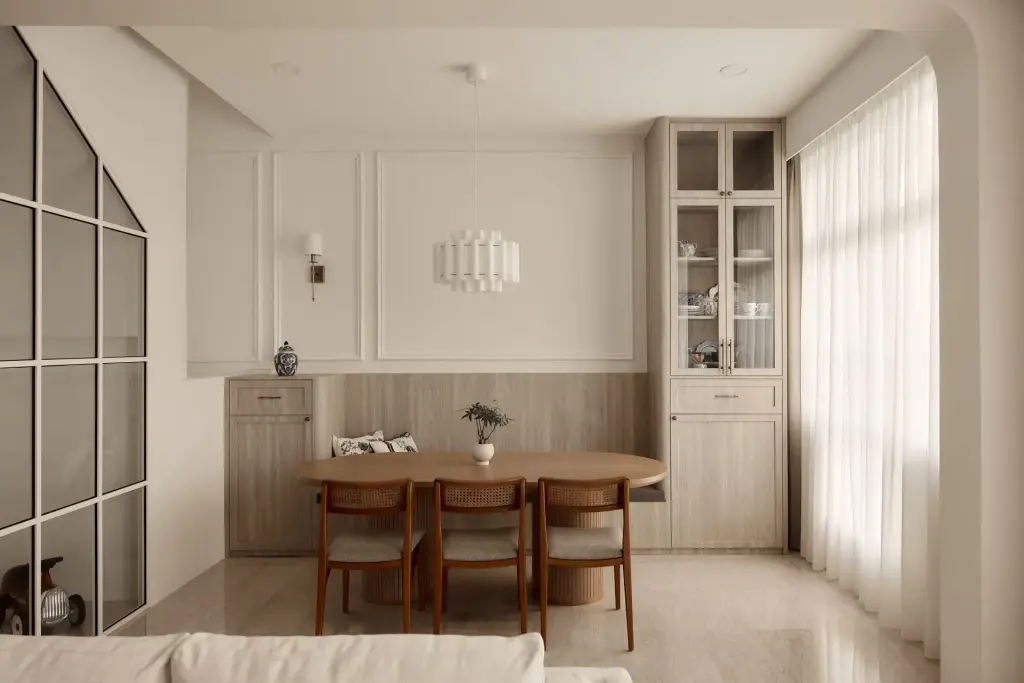 Minimalist dining room with wooden table and chairs. — at Eastwood, a modern luxury condo by IS Design Studio