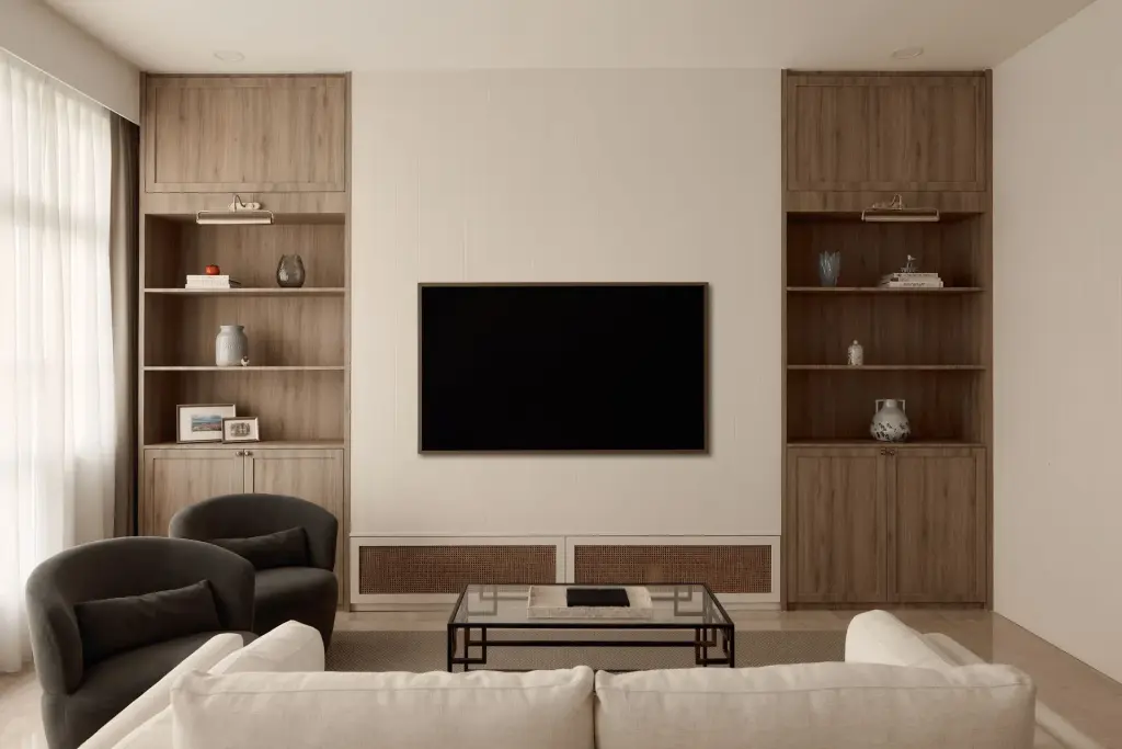 Modern living room with TV and wooden shelves. — at Eastwood, a modern luxury condo by IS Design Studio