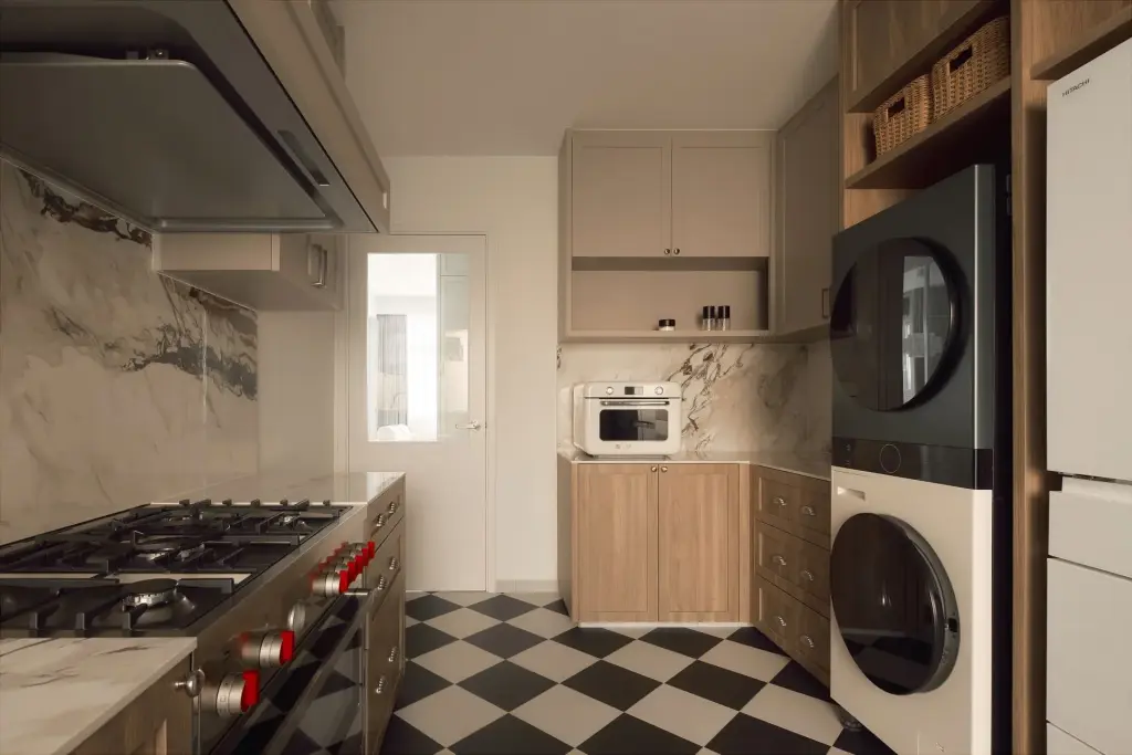 Modern kitchen with appliances and checkered floor — at Eastwood, a modern luxury condo by IS Design Studio