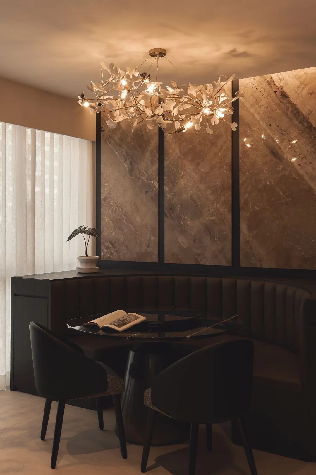 Elegant dining nook with chandelier and open book