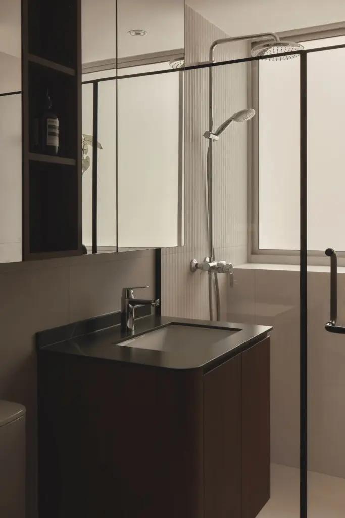 Modern bathroom with glass shower and sleek vanity.