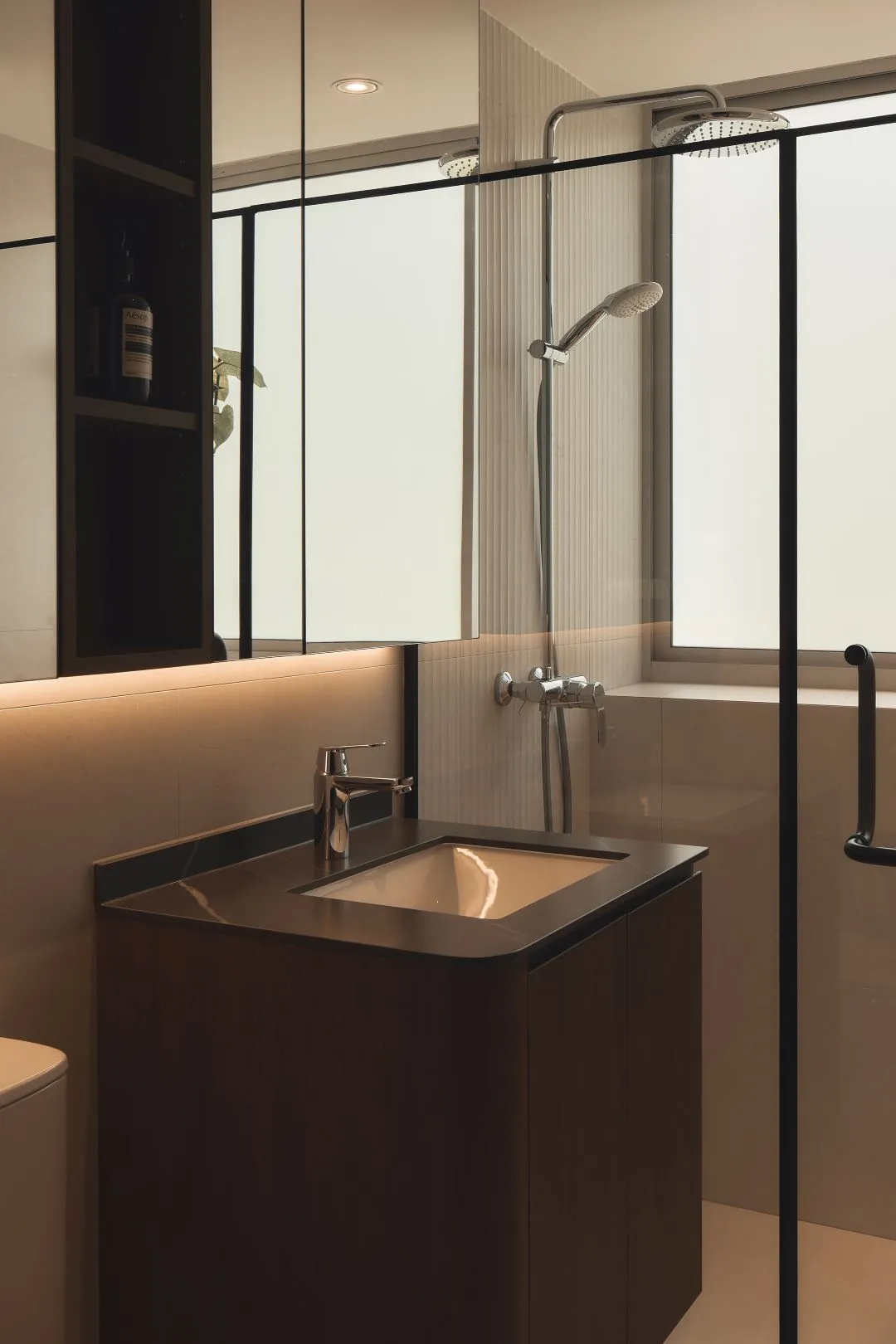 Modern bathroom with glass shower enclosure.