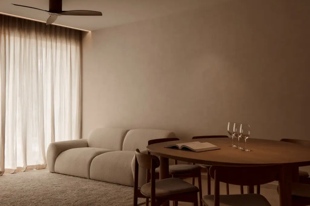 Minimalist living room with sofa and dining table.