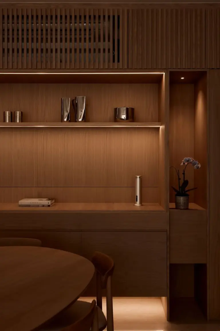 Modern wooden shelf with vases and orchid plant