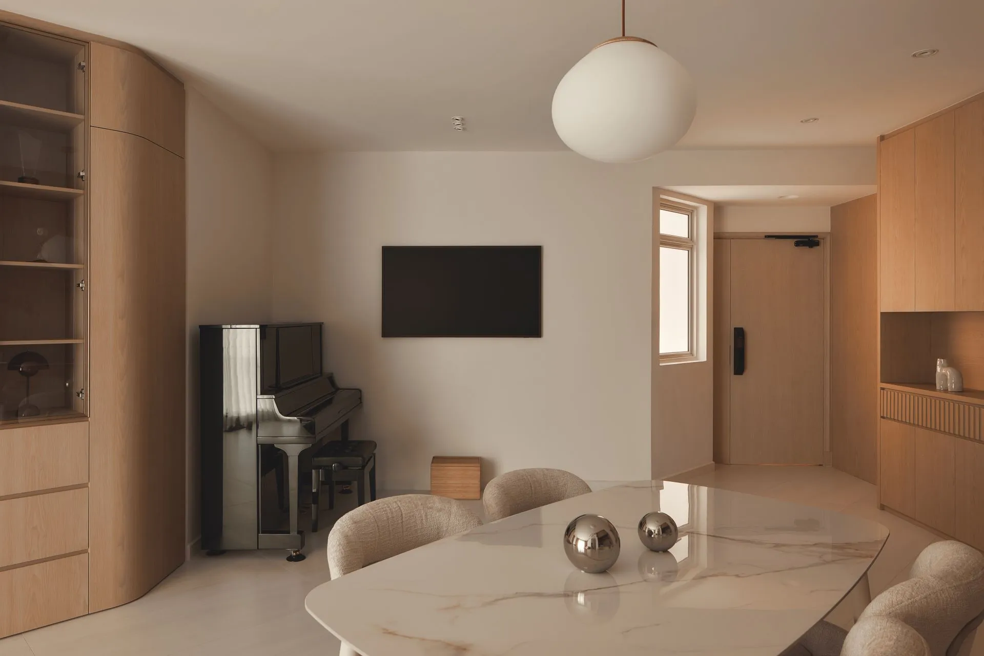 Minimalist living room with piano and dining table.