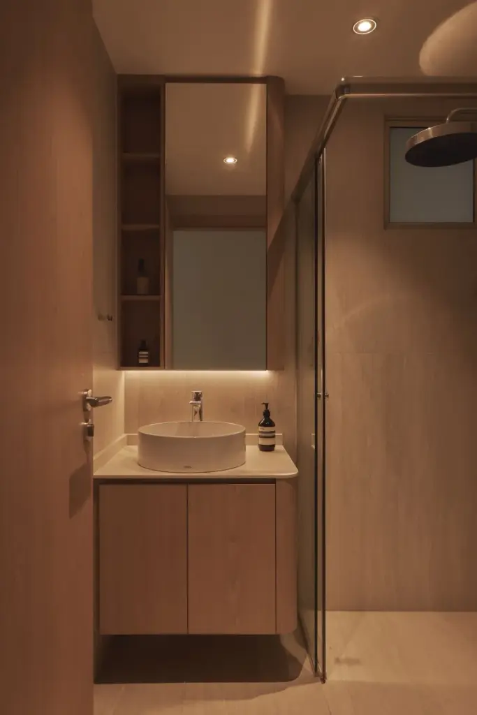 Modern minimalist bathroom with round sink and mirror.